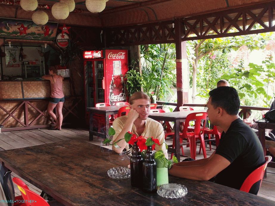 I am negotiating with a local guide about trekking in Bukit Lavang