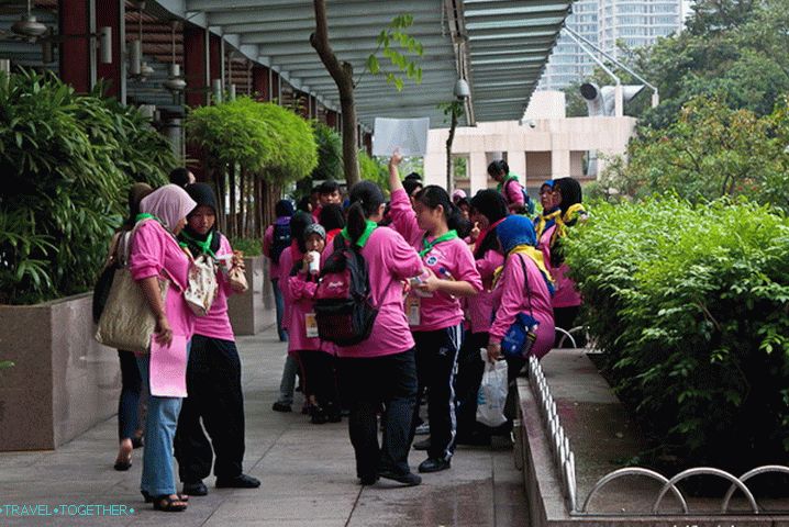 Schoolchildren are easily distinguishable in the crowd