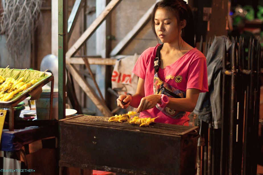 Fried squids on wooden skewers