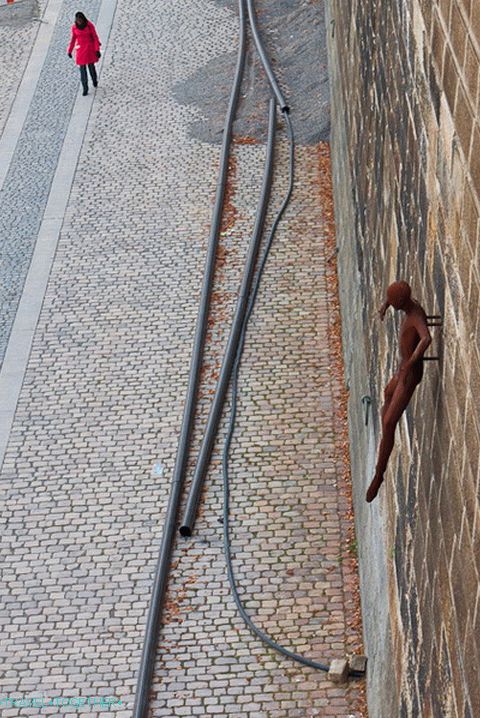 Embankment of the Vltava River and an unusual sculpture on the wall