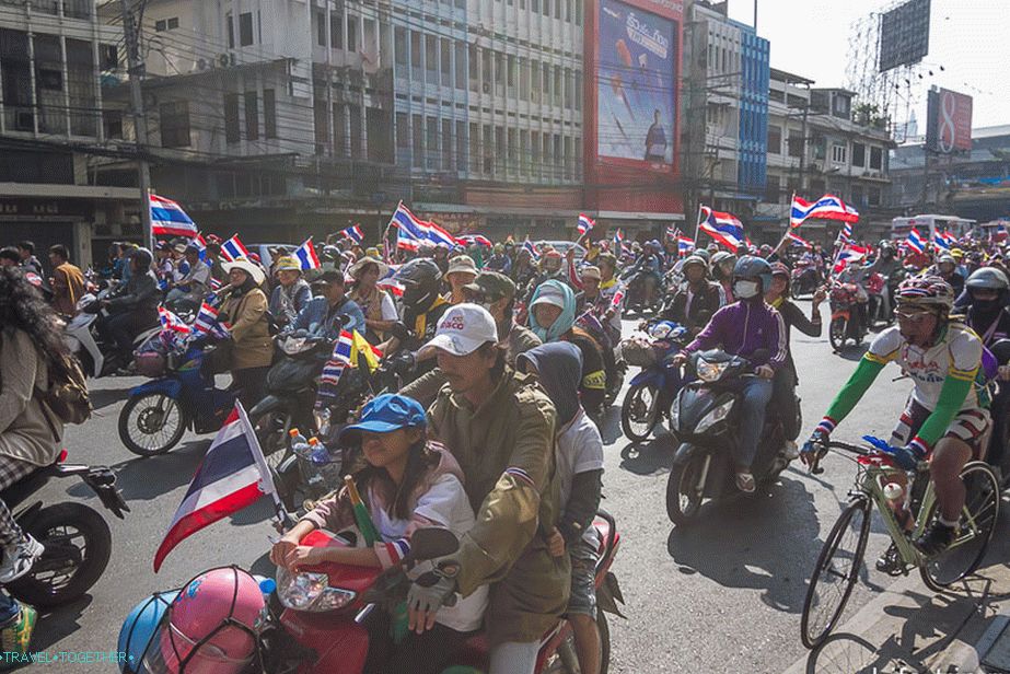 With children, on bikes and bicycles, with flags and smiles on their faces