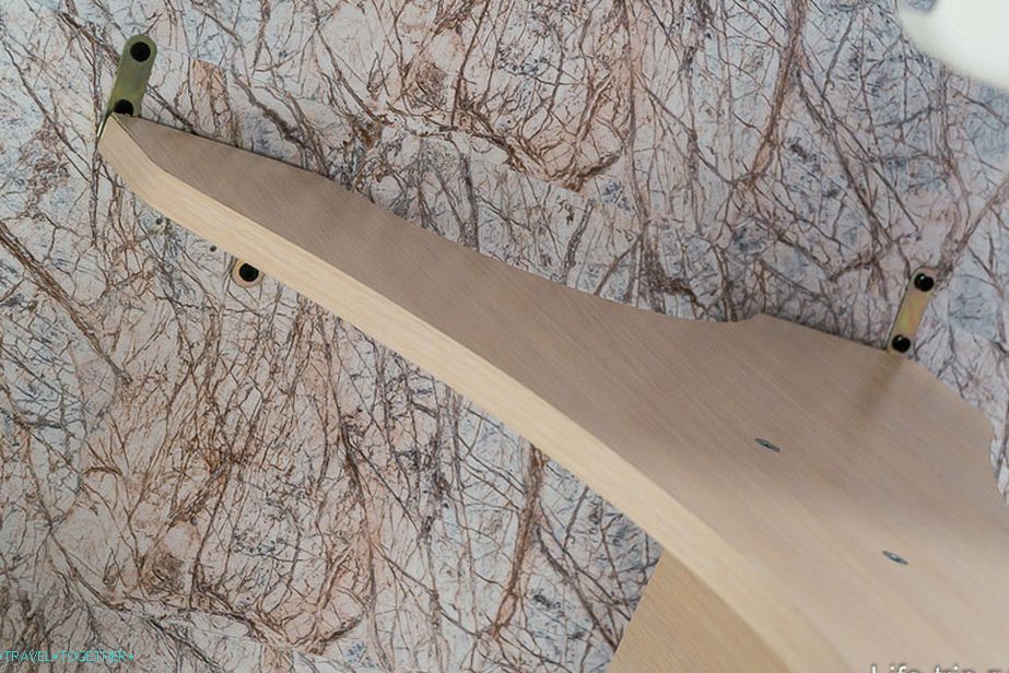 The table is fastened with screws and brackets