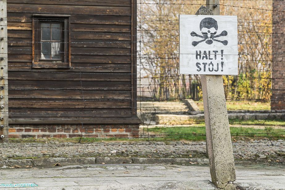 Barbed wire under tension around a concentration camp
