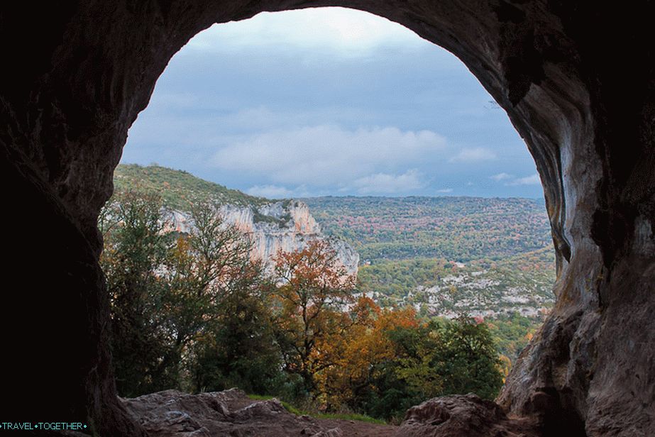 The cave ends with a window overlooking the mountains