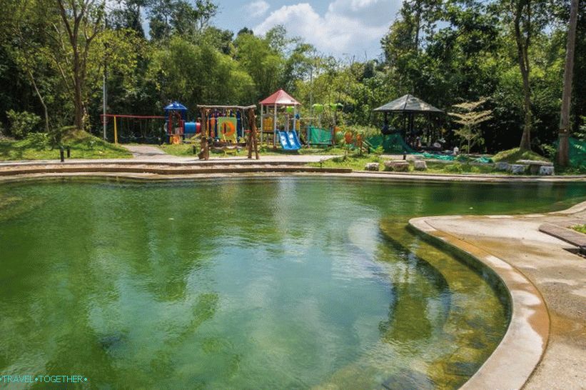 There is a playground behind the pool.
