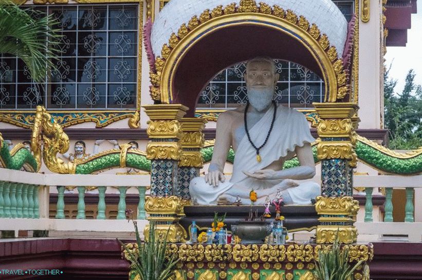 An ascetic is sitting near the temple