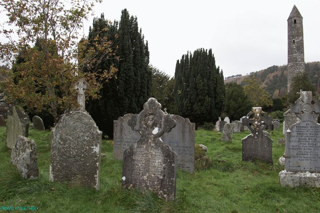 A classic photo of a cemetery with a tower.