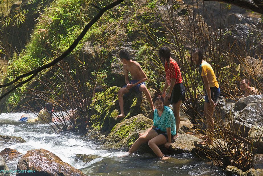 People are swimming all over the riverbed