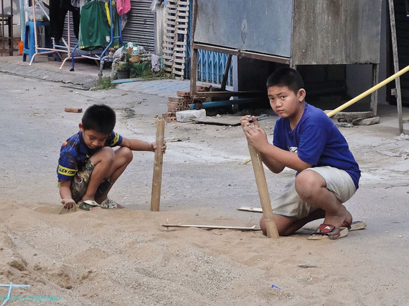 Children play with sand and bamboo