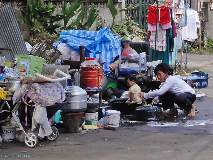 Washes the child near the hut