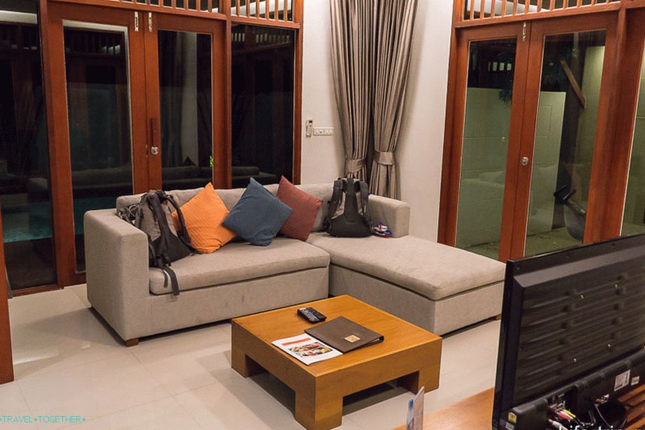 Spacious living room with sofa and TV