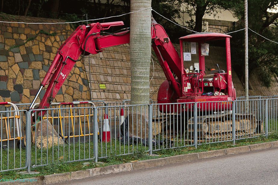 A small Chinese excavator placed in the dividing strip