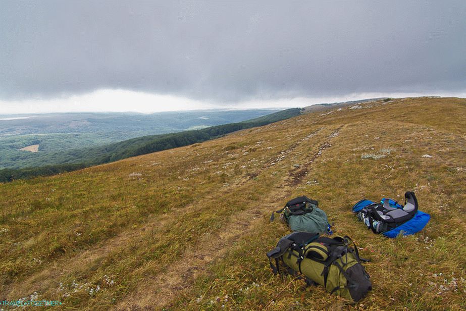 At the very top, everyone threw their backpacks and hide behind the rock from the wind and rest