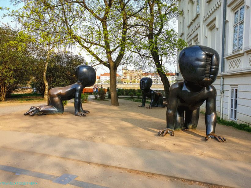 Sculpture of crawling babies in Prague - kids without a face